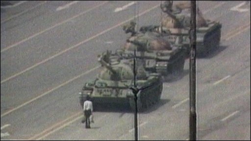 Protester in front of tank