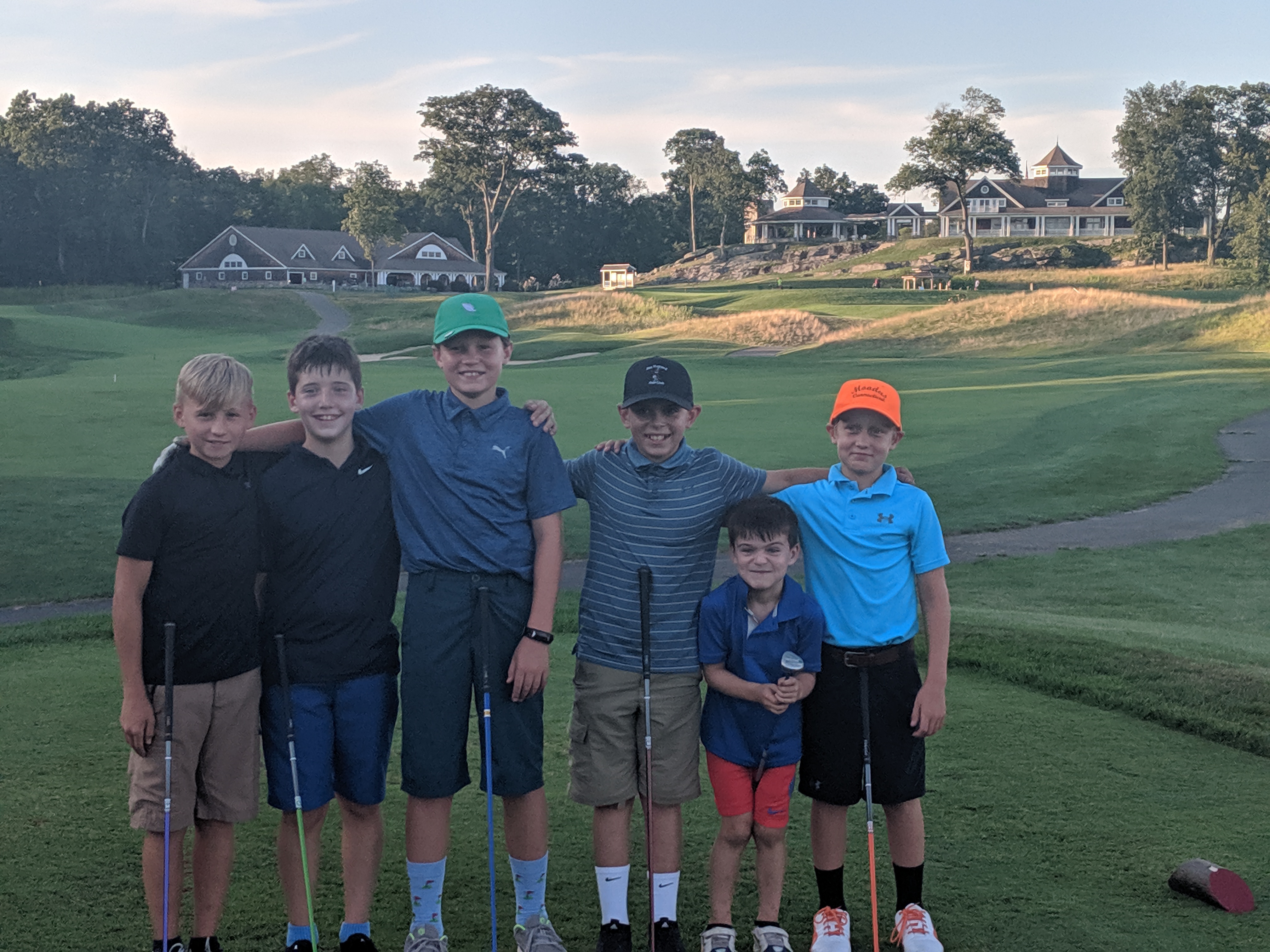 three boys on a golf course