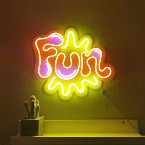 a neon sign with the word fun on it next to a cactus in a pot