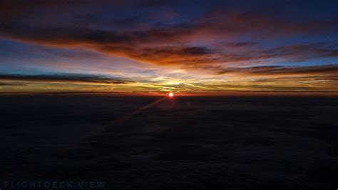 Sunset on the way back to London, from the flight deck of an Airbus ...