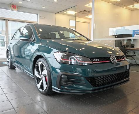 a blue volkswagen car is parked in a showroom