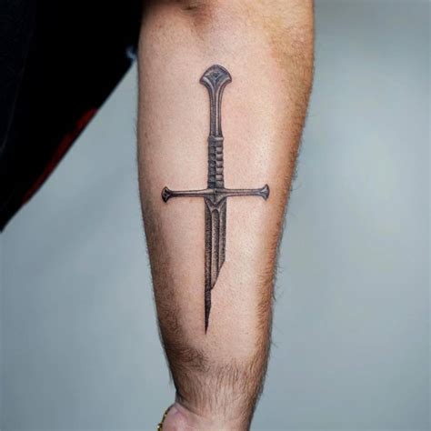 Broken sword tattoo located on the forearm.