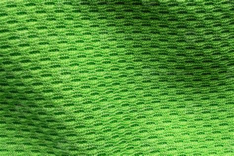 Green sports clothing fabric football shirt jersey texture close up ...