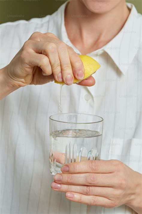 A person pouring liquid into a glass photo – Lemon Image on Unsplash