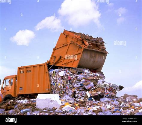 Garbage truck unloading waste at a garbage dump in North Rhine ...