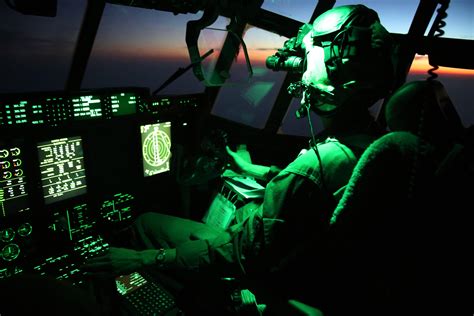 An illuminated KC-130J cockpit during an aerial refueling mission over ...