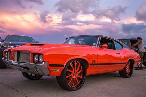 Trendsetting Red Oldsmobile Cutlass Rolling on Color Matched Forgiato ...