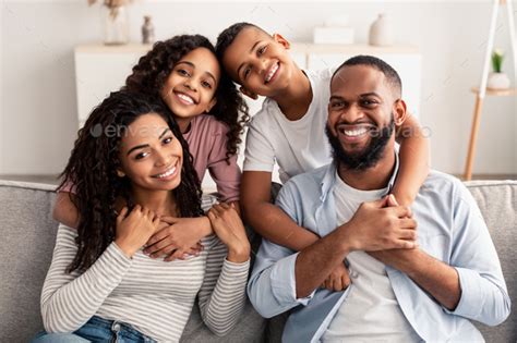 Portrait of happy black family smiling at home Stock Photo by Prostock ...