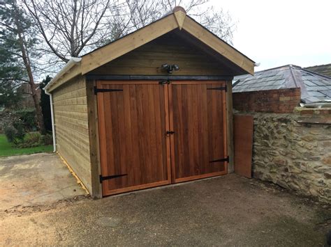 Hardwood garage doors. Traditional, double opening design. Really does ...