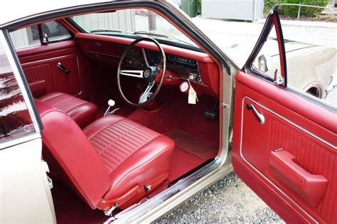 the interior of an old car with red leather seats and steering wheel ...