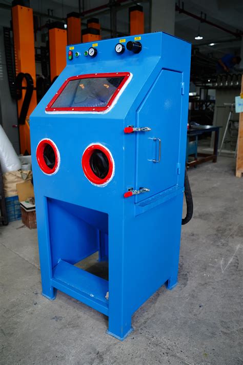 a blue machine with red and black buttons on it's face in a warehouse