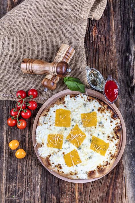 Four Types of Cheese Italian Pizza on a Wooden Floor Stock Photo ...