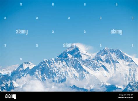 Mount Everest Himalaya mountain range Aerial view with clouds and now ...