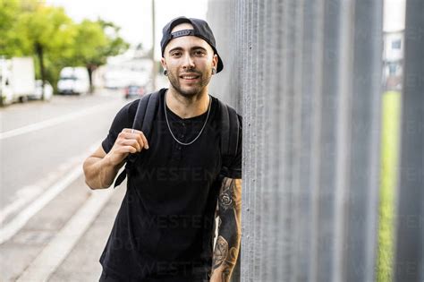 Portrait of a young smiling man with baseball cap in the city stock photo