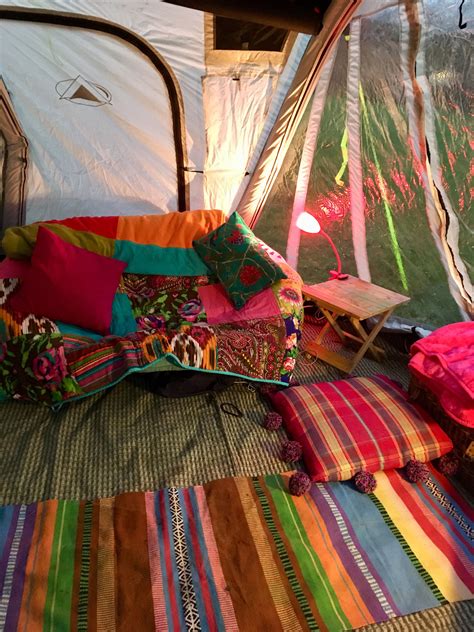 the inside of a tent with many colorful pillows and blankets on the ...