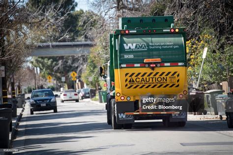 A Waste Management Inc. garbage collection truck drives through a ...