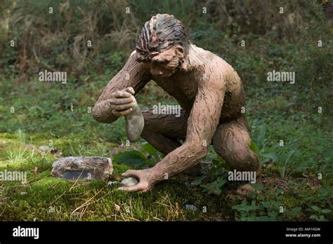 Life size model Homo erectus using stone tools Dinosaur Park France ...