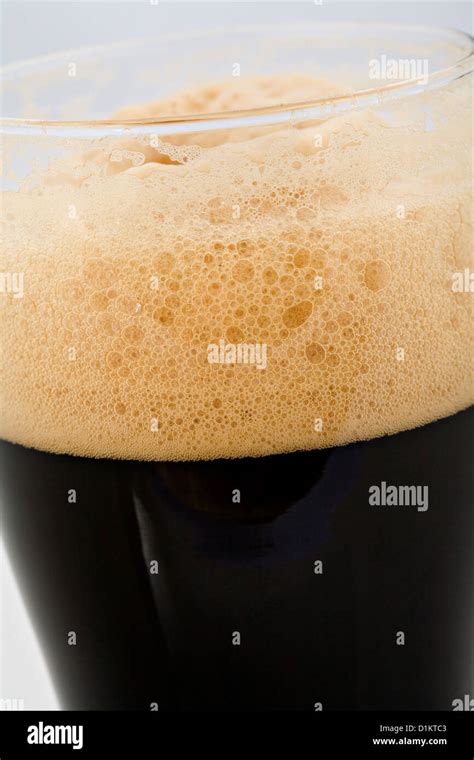 The foam head on stout beer Stock Photo - Alamy