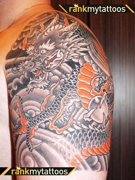 another black and grey with orange. | Dragon tattoo, Dragon tattoo arm ...