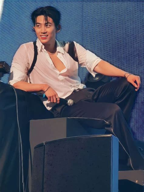 a young man sitting on top of a chair next to a tv monitor and microphone