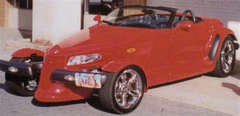 a red sports car parked next to a building