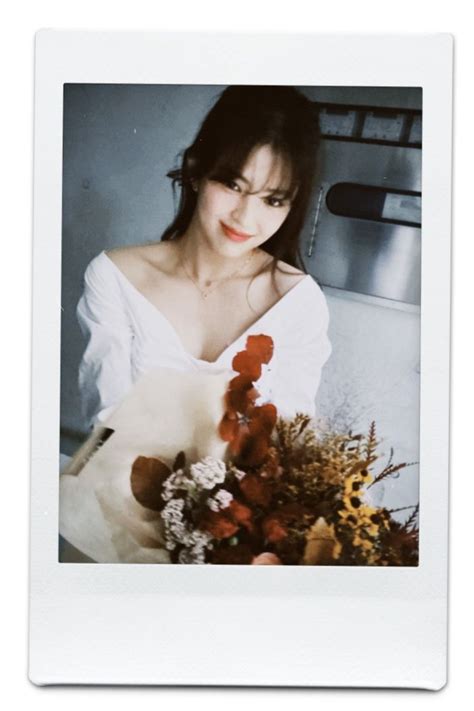 a woman holding a bouquet of flowers in front of a white background ...