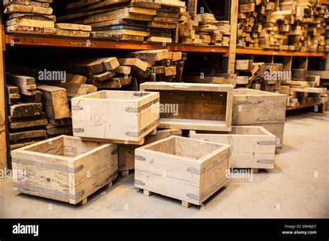 Shelves with wooden planks and a stack of wooden crates in a warehouse ...