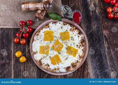 Four Types of Cheese Italian Pizza on a Wooden Floor Stock Photo ...