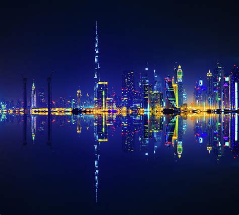 Dubai Skyline Reflection At Night by Serts