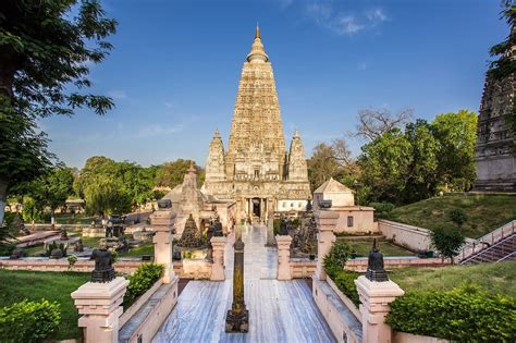 a large building with a fountain in front of it and many trees around ...