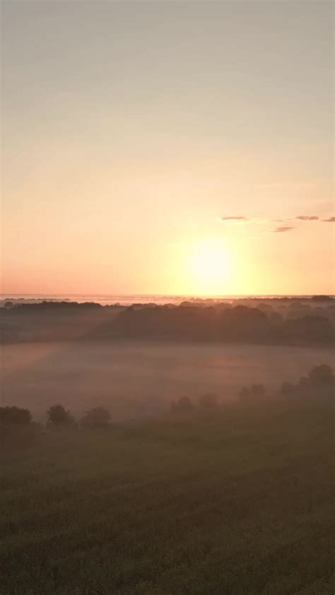 a sunrise over a foggy landscape 30904279 Stock Video at Vecteezy