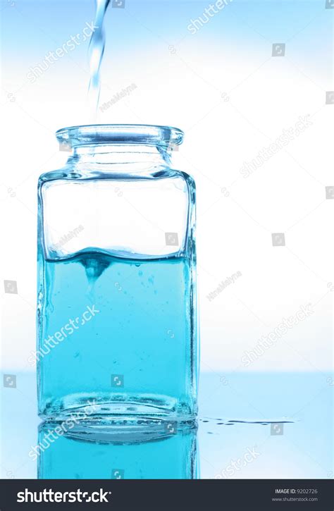 Pouring A Liquid Into A Glass Container Stock Photo 9202726 : Shutterstock