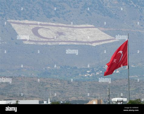 NORTH CYPRUS. Turkish flag flying on a building with a giant flag on ...