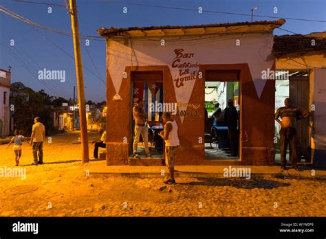 street scene at night in the city of Trinidad, bar, nightlife, family ...