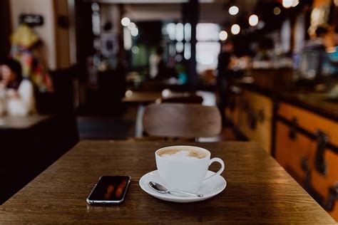 HD wallpaper: Cup of coffee on table in cafe, interior, tech ...