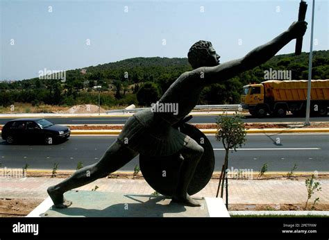 The statue of Pheidippides is seen at the Marathon route in the port of ...