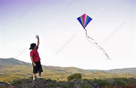 Boy Flying Kite - Stock Image - C001/0280 - Science Photo Library