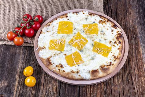 Four Types of Cheese Italian Pizza on a Wooden Floor Stock Photo ...