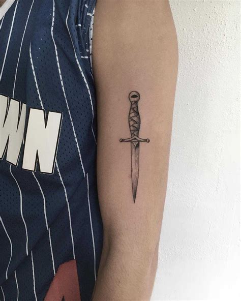 Small dagger tattoo on the arm - Tattoogrid.net