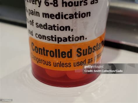 Close-up of a pain medication bottle featuring the warning... News ...