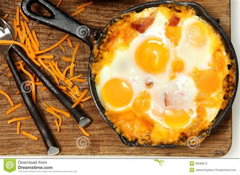 Skillet Baked Eggs and Sausage with Cheese Stock Photo - Image of ...