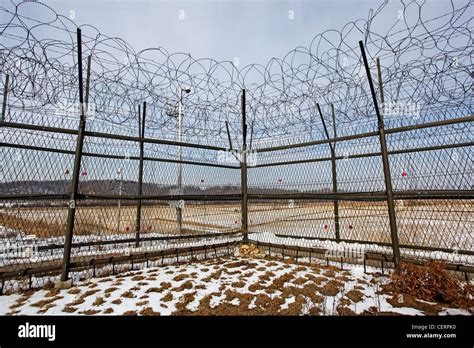 Barbed wire fence and South Korean flag at the DMZ, De-militarised Zone ...