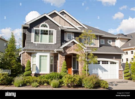 new beautiful suburban house with blue sky and clouds Stock Photo - Alamy