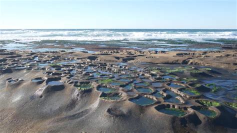 Eroded Tide Pool Rock Formation in California. Sunset Sky Reflection in ...