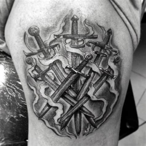 3D like black ink various medieval sword tattoo on thigh - Tattooimages.biz