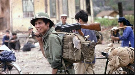 A vietnamese soldier marching through a village near the Vietnam ...