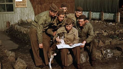 WWII soldiers reading a soft cover book, given to them as entertainment ...