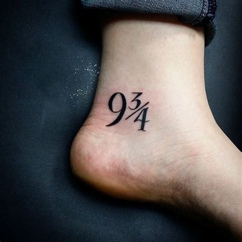 Symbolical numbers 9 3/4 tattoo on ankle in dark black ink ...