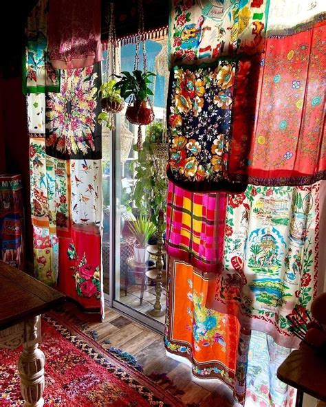 a room filled with lots of colorful rugs and windows covered in ...