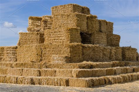 Large stack of square hay bales | Nature Stock Photos ~ Creative Market